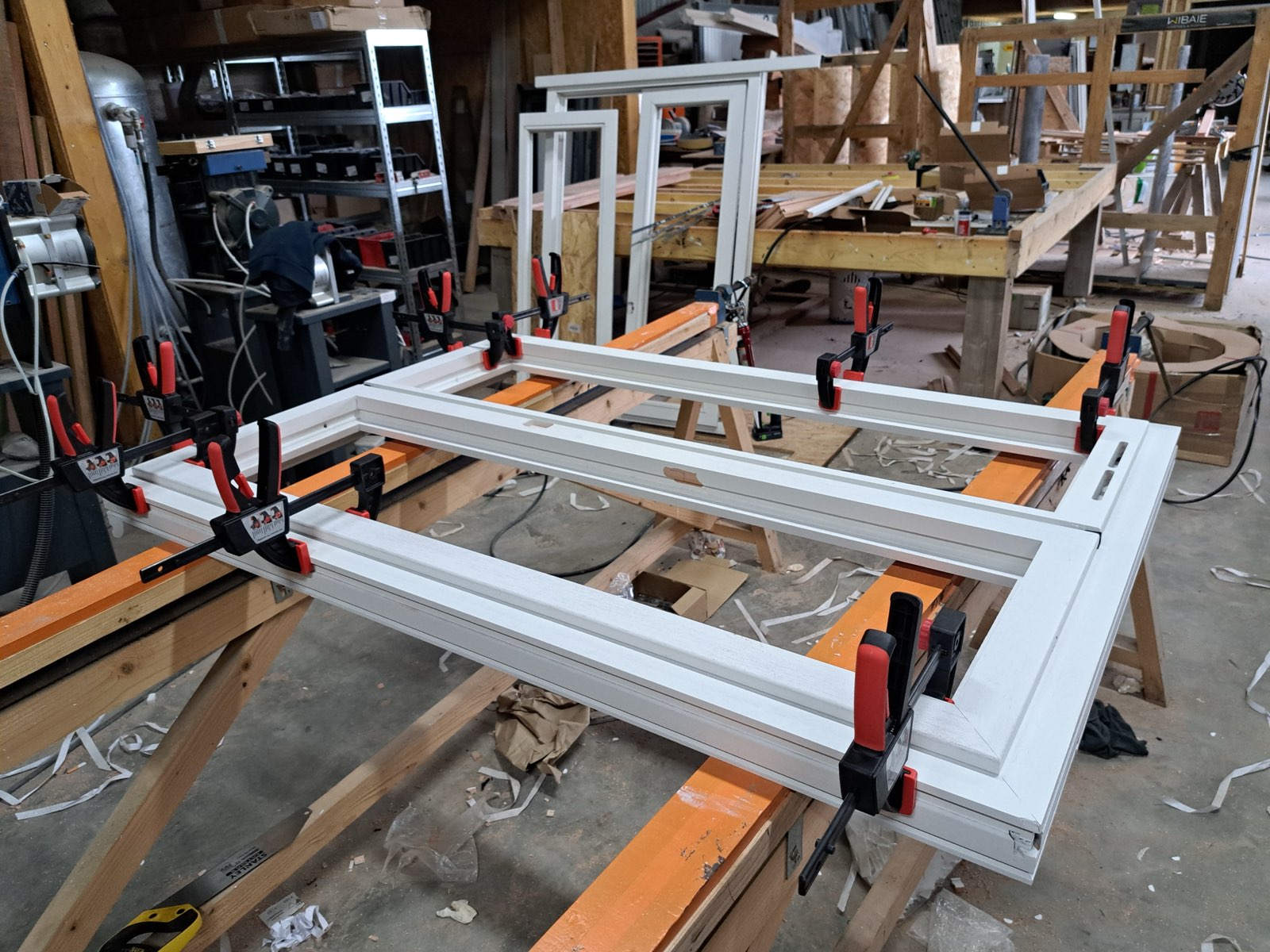 Assemblage d'un dormant de fenêtre PVC maintenu par des serre-joints d'angle — atelier Dagicour