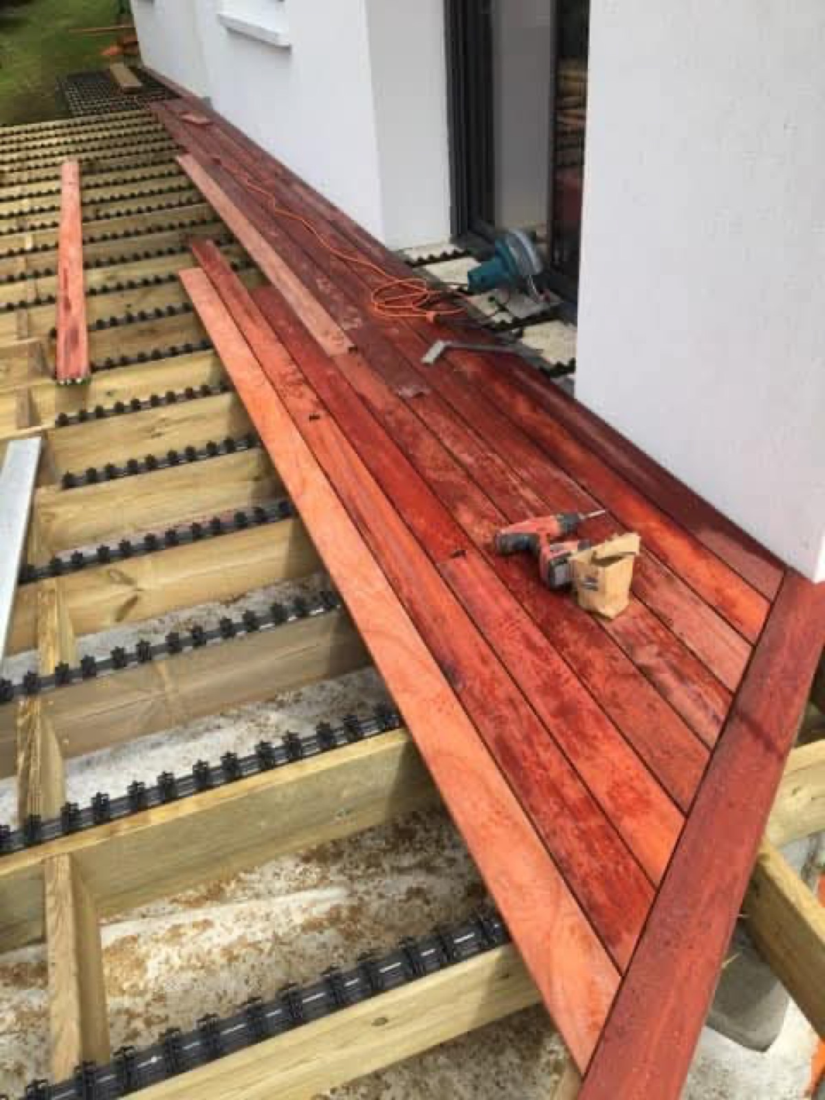 Pose de lames de terrasse en bois exotique rouge à la visseuse — chantier Dagicour