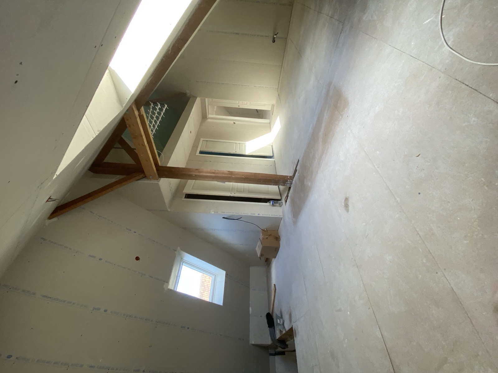 Avant travaux : ossature bois brute et structure de mezzanine grillagée sous charpente, combles en chantier — Dagicour